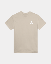 The Creamfields Chrome Logo Sand T-Shirt features a classic fit and short sleeves in a heavyweight beige cotton, accented by a small white abstract logo on the upper left chest. Displayed flat against a plain background, it’s the perfect choice for casual wear.