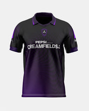 A short-sleeve polo shirt in black and purple, featuring a purple collar, purple sleeve accents, a central shield crest, and 'PEPSI PRESENTS CREAMFIELDS' printed in white across the chest.