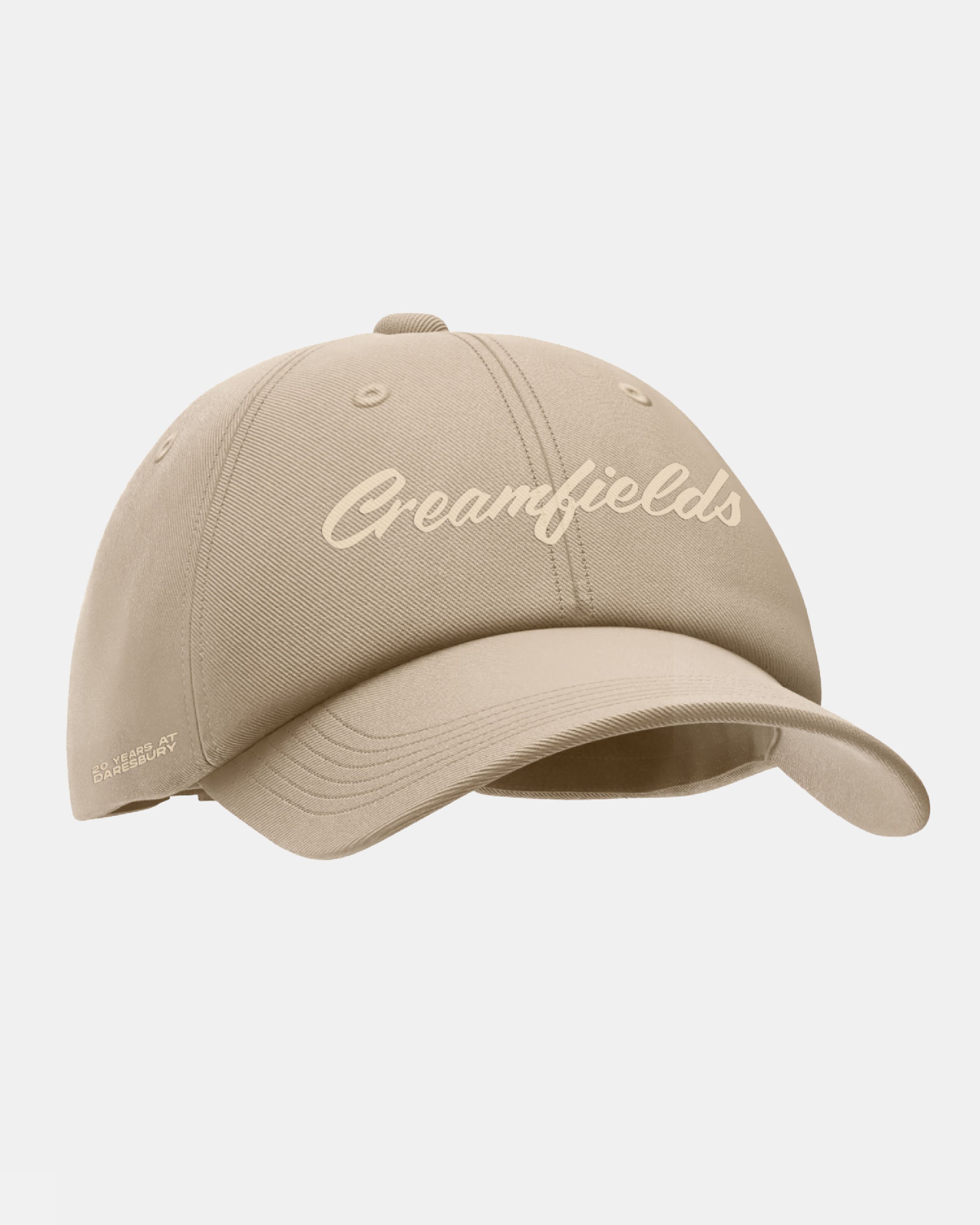 A beige Click & Collect Creamfields Evergreen Denim Cap from Creamfields 2026 Click & Collect, featuring "Creamfields" in script on the front and a small Daniel Arsham logo on the side, displayed against a plain white background.