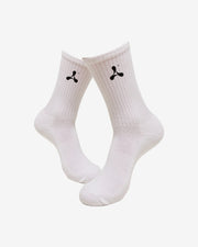 Creamfields 2025 Crew Socks by Creamfields: white crew socks featuring a small black abstract logo on the sides, shown against a plain white background.