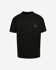 Black t-shirt with a small logo on a light gray background