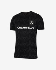 The Creamfields 2025 Football T-Shirt is a black tee with a subtle swirl design, a bold white CREAMFIELDS logo on the chest, and an abstract symbol patch on the left side.