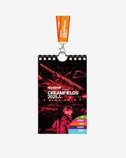 The Creamfields 2025 Lanyard by Creamfields shows a DJ on stage with vivid red lighting, colored tabs for Thursday to Sunday at the bottom, and comes with an orange lanyard attached at the top.